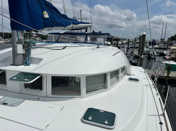 Wylicat Yacht Photos Pics Catamaran Lagoon 380, 2000 model, docked at marina under cloudy sky.