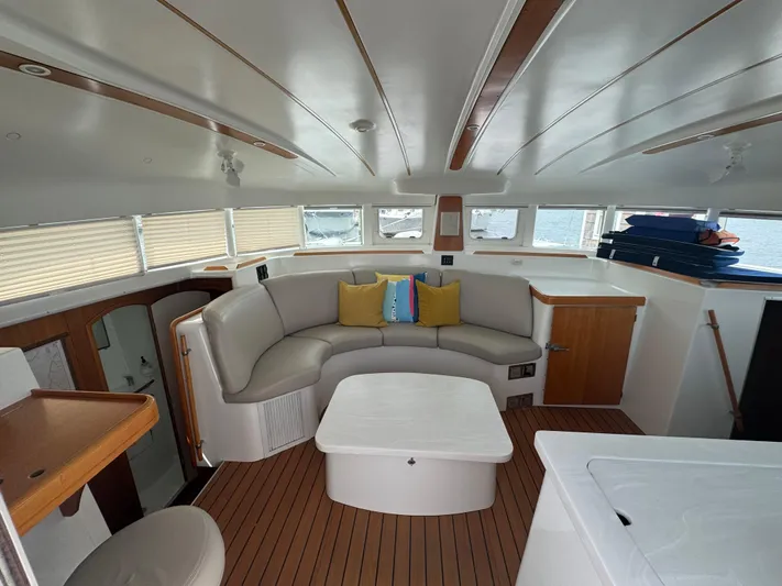 Wylicat Yacht Photos Pics Interior of 2000 Lagoon 380 catamaran with modern seating and wooden accents.
