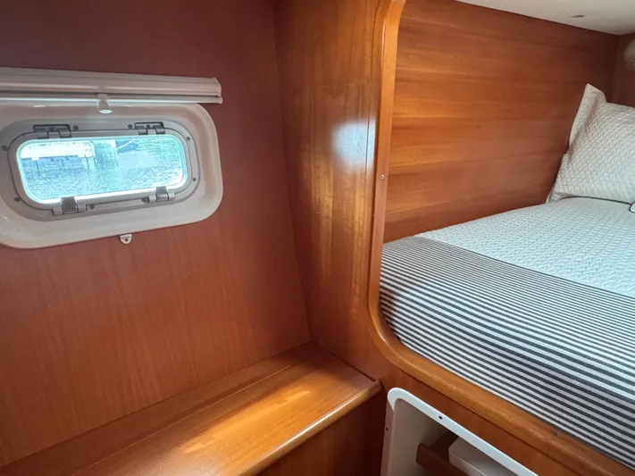 Wylicat Yacht Photos Pics Interior cabin of 2000 Lagoon 380 catamaran with wooden finish and cozy bed.