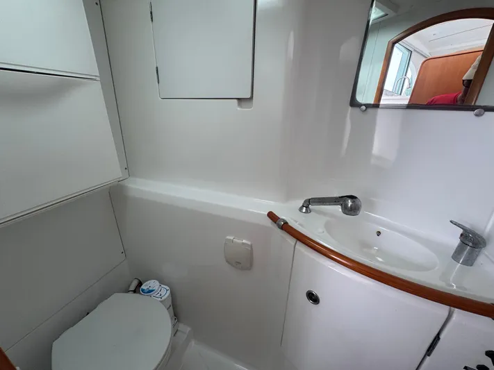 Wylicat Yacht Photos Pics Bathroom interior of 2000 Lagoon 380 catamaran with sink and toilet.