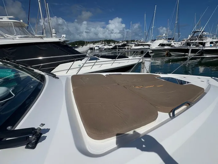  Yacht Photos Pics 2015 Pursuit SC 365i Sport Coupe at marina with sunpad, clear sky, and boats in background.