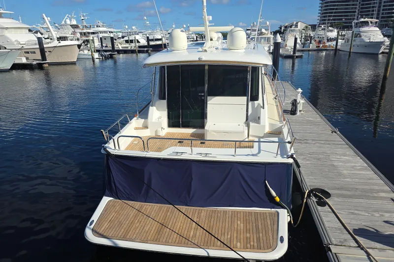 Vertical Yacht Photos Pics 2017 Sabre 48 Salon Express yacht docked at marina, rear view.