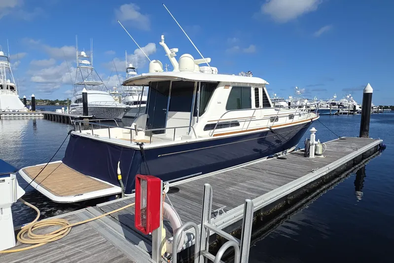 Vertical Yacht Photos Pics 2017 Sabre 48 Salon Express yacht docked at marina under clear blue sky.
