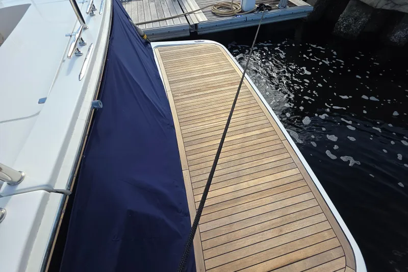 Vertical Yacht Photos Pics 2017 Sabre 48 Salon Express yacht with wooden deck at dockside.