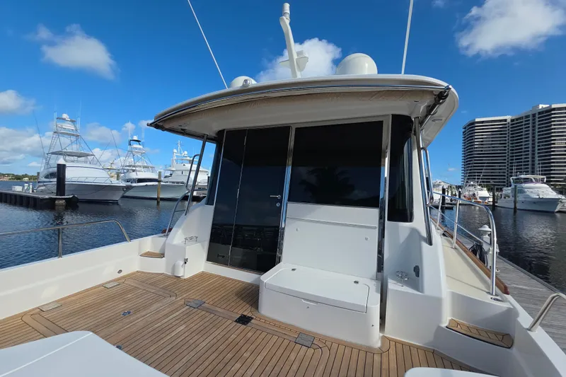 Vertical Yacht Photos Pics 2017 Sabre 48 Salon Express yacht docked at marina with clear blue sky.