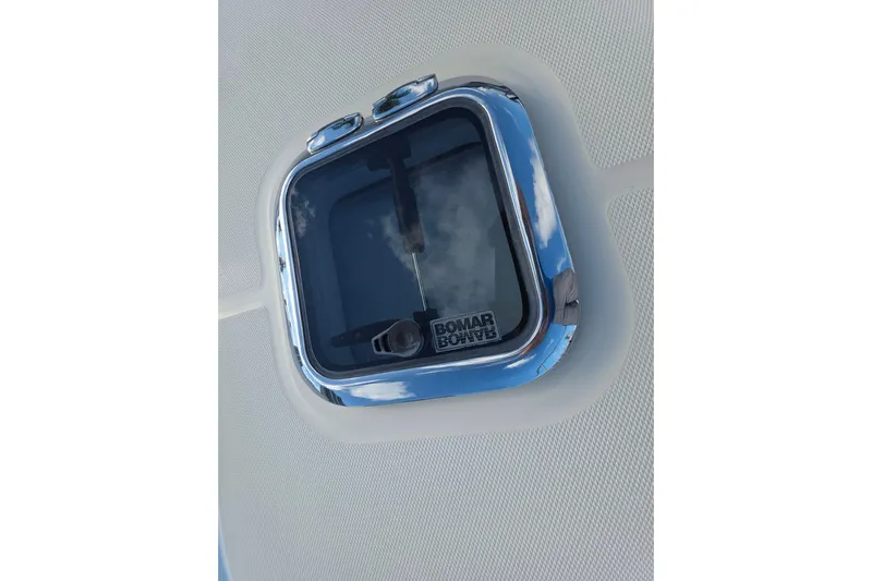 Vertical Yacht Photos Pics Bomar hatch on 2017 Sabre 48 Salon Express yacht, reflecting sky.