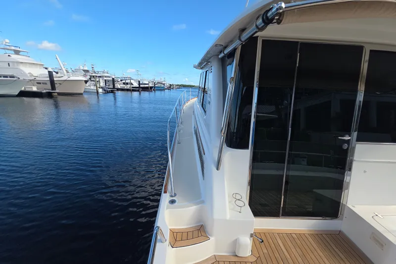 Vertical Yacht Photos Pics 2017 Sabre 48 Salon Express yacht docked at marina, clear blue sky.