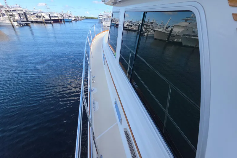 Vertical Yacht Photos Pics 2017 Sabre 48 Salon Express yacht docked at marina, reflecting water and boats.