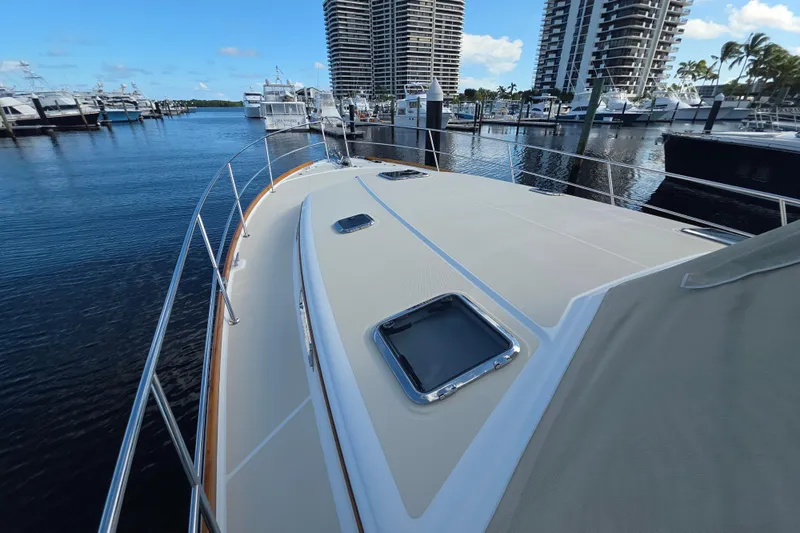 Vertical Yacht Photos Pics 2017 Sabre 48 Salon Express yacht docked at marina with high-rise buildings.