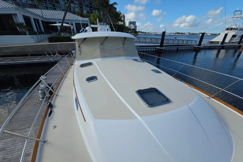 Vertical Yacht Photos Pics 2017 Sabre 48 Salon Express yacht docked at marina under blue sky.