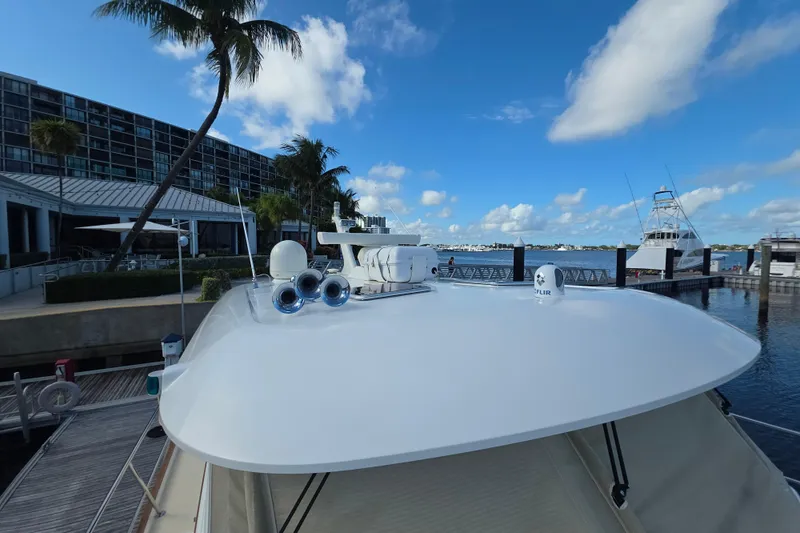 Vertical Yacht Photos Pics 2017 Sabre 48 Salon Express yacht docked at marina, clear blue sky, palm trees.