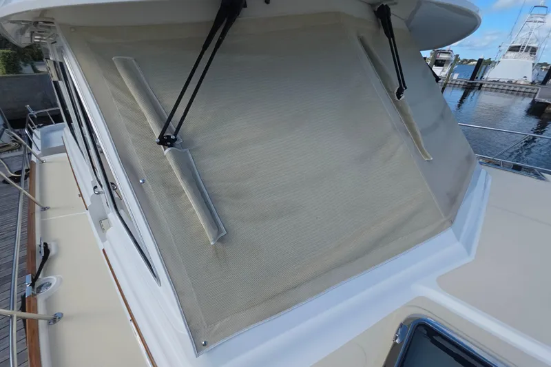 Vertical Yacht Photos Pics 2017 Sabre 48 Salon Express yacht with covered windows at a marina.