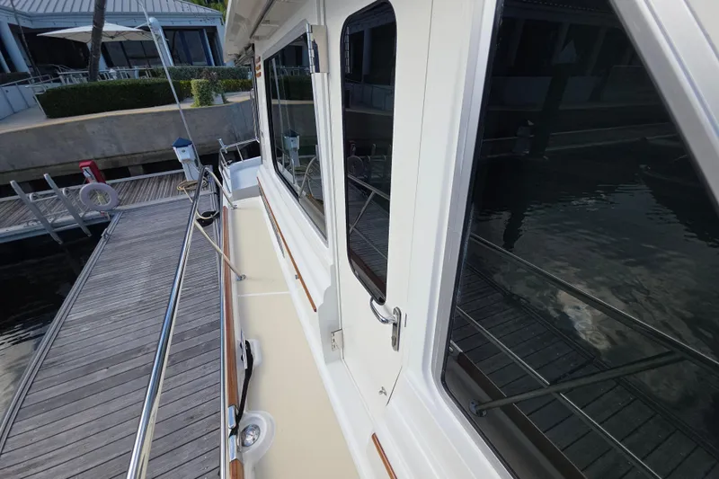 Vertical Yacht Photos Pics 2017 Sabre 48 Salon Express yacht docked, showcasing sleek exterior and reflective windows.