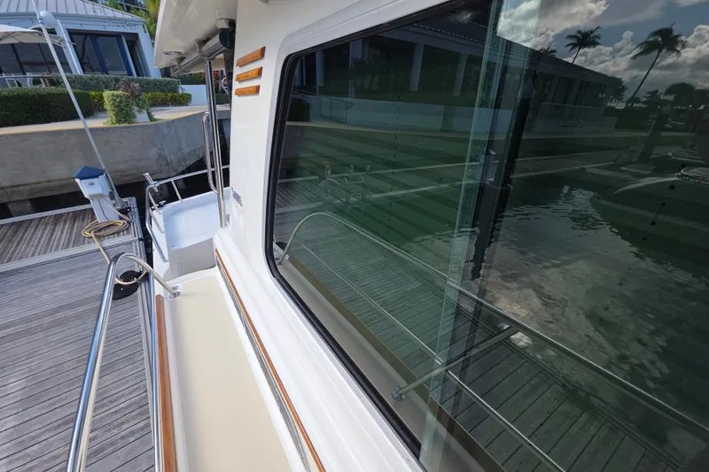 Vertical Yacht Photos Pics 2017 Sabre 48 Salon Express yacht docked, reflecting water and sky.