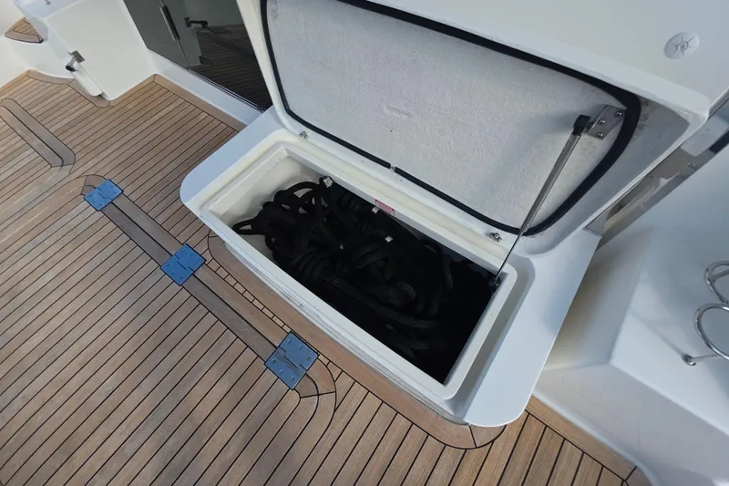 Vertical Yacht Photos Pics Open storage compartment on 2017 Sabre 48 Salon Express boat with coiled ropes inside.