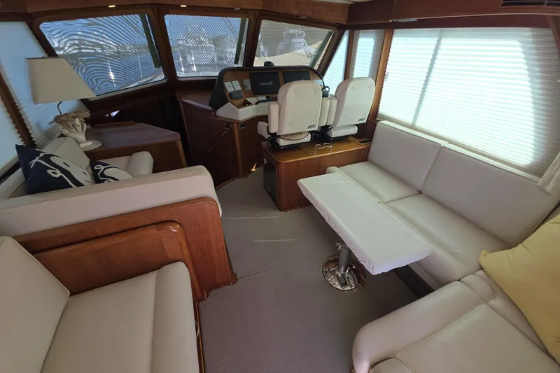 Vertical Yacht Photos Pics Interior of 2017 Sabre 48 Salon Express yacht with elegant seating and helm station.