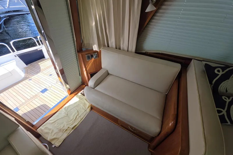 Vertical Yacht Photos Pics Interior of 2017 Sabre 48 Salon Express yacht with beige seating and wooden flooring.