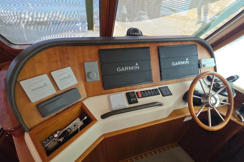 Vertical Yacht Photos Pics 2017 Sabre 48 Salon Express helm with Garmin navigation displays and wooden steering wheel.
