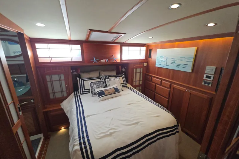 Vertical Yacht Photos Pics Luxurious bedroom interior of 2017 Sabre 48 Salon Express yacht with elegant wood finish.