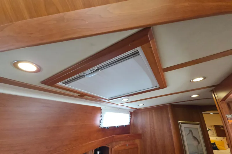 Vertical Yacht Photos Pics Interior ceiling of 2017 Sabre 48 Salon Express with recessed lighting and wood finish.