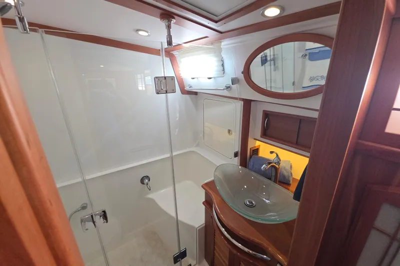 Vertical Yacht Photos Pics Luxurious bathroom in 2017 Sabre 48 Salon Express yacht with glass sink and shower.