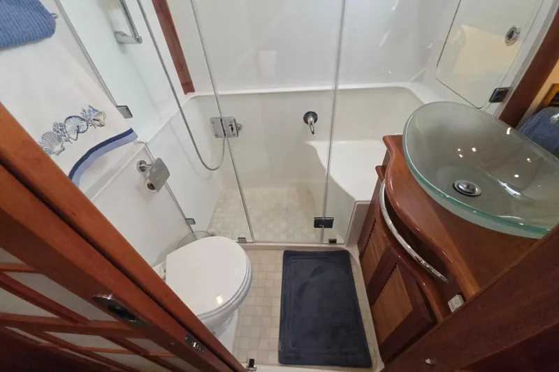 Vertical Yacht Photos Pics Luxurious bathroom in 2017 Sabre 48 Salon Express yacht with glass sink and shower.