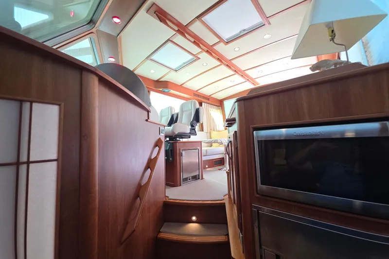 Vertical Yacht Photos Pics Interior of 2017 Sabre 48 Salon Express yacht, featuring luxurious wood finishes and modern amenities.