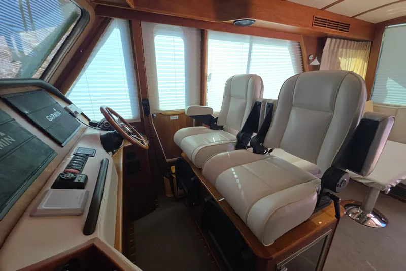 Vertical Yacht Photos Pics Interior of 2017 Sabre 48 Salon Express yacht with leather seating and navigation controls.