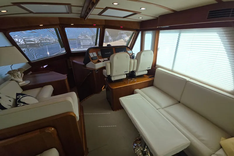 Vertical Yacht Photos Pics Interior of 2017 Sabre 48 Salon Express yacht with luxurious seating and helm.