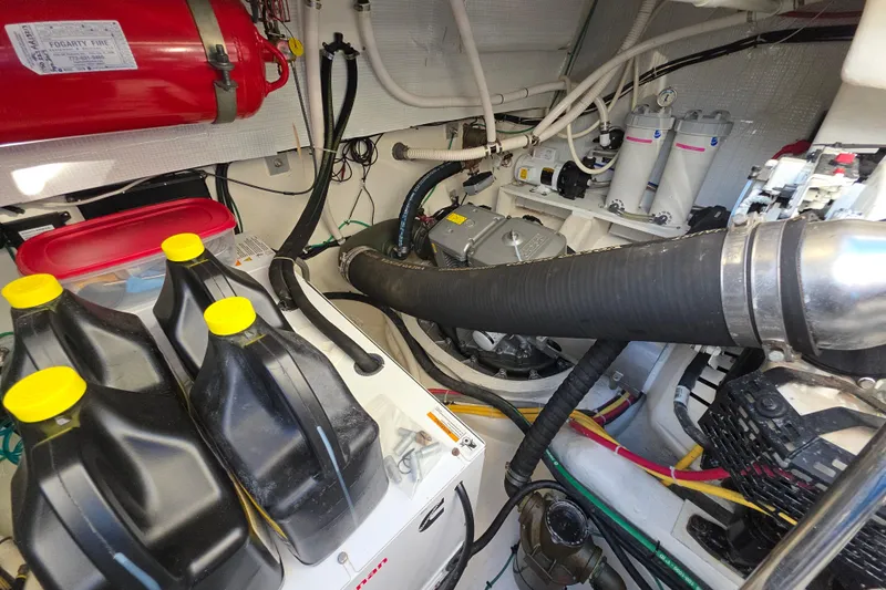 Vertical Yacht Photos Pics Engine room of 2017 Sabre 48 Salon Express with fire extinguisher and oil containers.