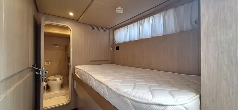 Bella Vita Yacht Photos Pics Cabin interior of 2020 Azimut Magellano 66 yacht with bed and ensuite bathroom.