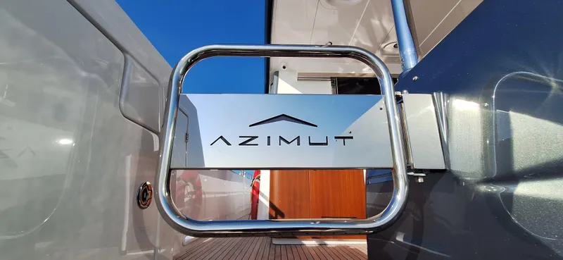 Bella Vita Yacht Photos Pics Azimut Magellano 66 yacht gate with logo, 2020 model, sleek design, blue sky background.