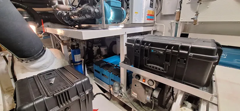 Bella Vita Yacht Photos Pics Engine room of 2020 Azimut Magellano 66 yacht with equipment and storage cases.