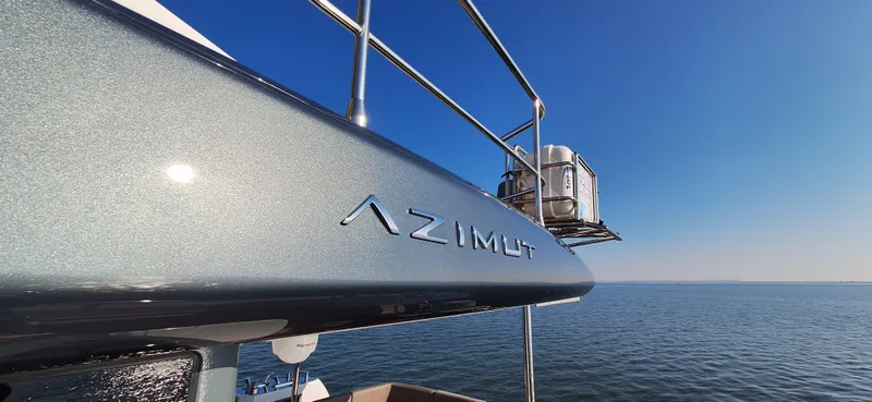 Bella Vita Yacht Photos Pics Azimut Magellano 66 yacht, 2020 model, on open water under clear blue sky.