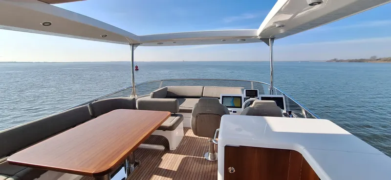 Bella Vita Yacht Photos Pics Luxurious 2020 Azimut Magellano 66 yacht deck with ocean view and elegant seating area.
