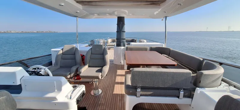Bella Vita Yacht Photos Pics Azimut Magellano 66 yacht deck, 2020 model, featuring seating and dining area on open water.