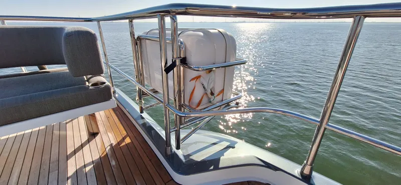 Bella Vita Yacht Photos Pics Azimut Magellano 66 yacht deck with ocean view, featuring sleek railing and seating, 2020 model.