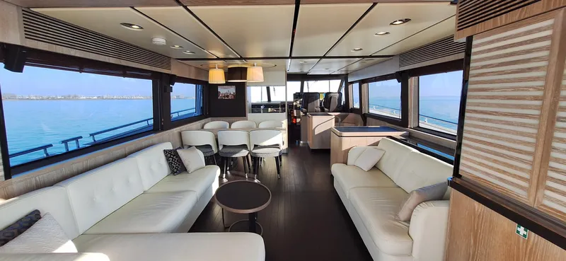 Bella Vita Yacht Photos Pics Luxurious interior of 2020 Azimut Magellano 66 yacht with elegant seating and ocean view.