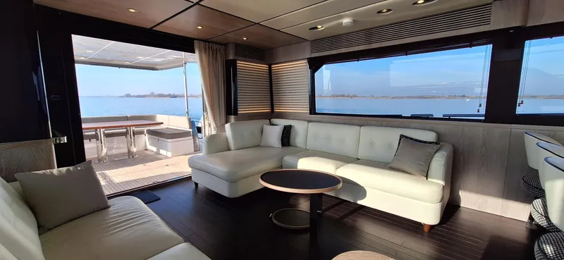 Bella Vita Yacht Photos Pics Luxurious interior of 2020 Azimut Magellano 66 yacht with elegant seating and ocean view.