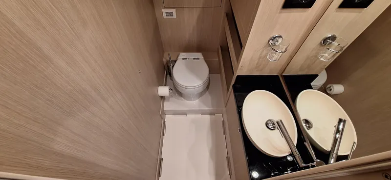 Bella Vita Yacht Photos Pics Luxurious bathroom in 2020 Azimut Magellano 66 yacht with modern fixtures and elegant design.