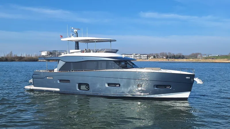 Bella Vita Yacht Photos Pics Azimut Magellano 66 yacht, 2020 model, cruising on calm waters under a clear blue sky.