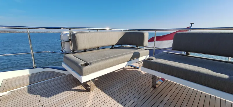 Bella Vita Yacht Photos Pics Luxury deck seating on 2020 Azimut Magellano 66 yacht, overlooking serene ocean view.