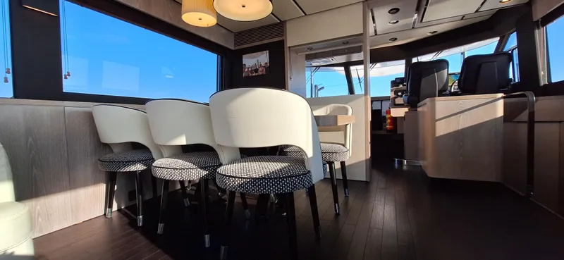 Bella Vita Yacht Photos Pics Luxurious interior of 2020 Azimut Magellano 66 yacht with elegant seating and modern design.