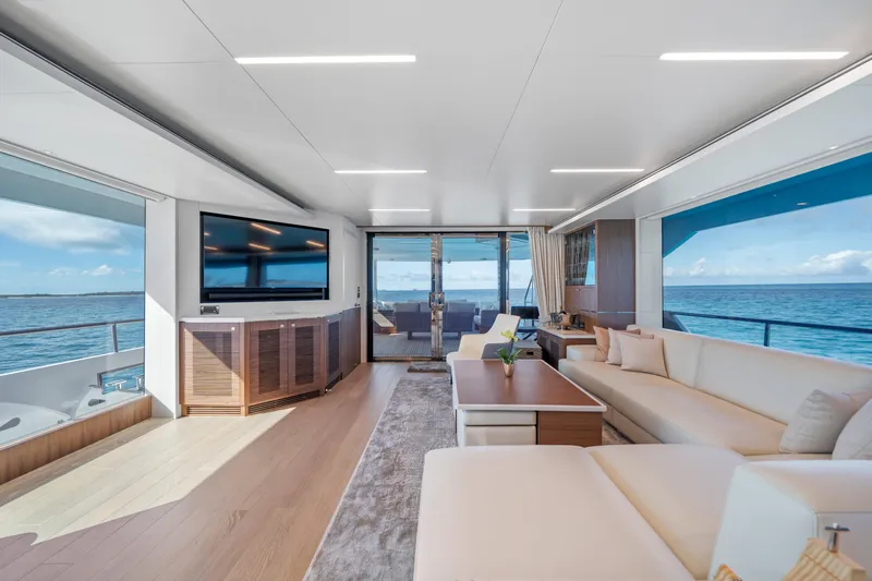 Rio Yacht Photos Pics Luxurious 2023 Horizon FD90 yacht interior with ocean view, modern furnishings, and large TV.