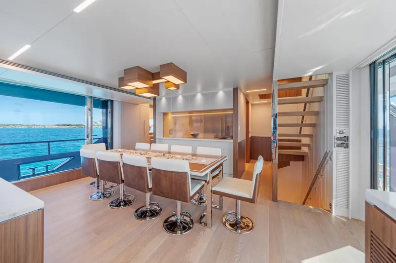 Rio Yacht Photos Pics Luxurious dining area on 2023 Horizon FD90 yacht with ocean view and modern decor.