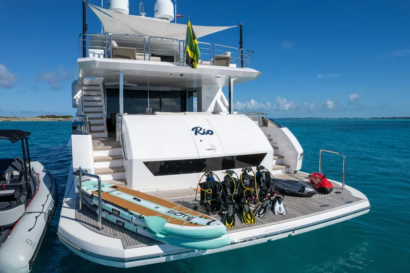 Rio Yacht Photos Pics Luxury Horizon FD90 yacht with water sports gear, anchored in clear blue sea, 2023 model.