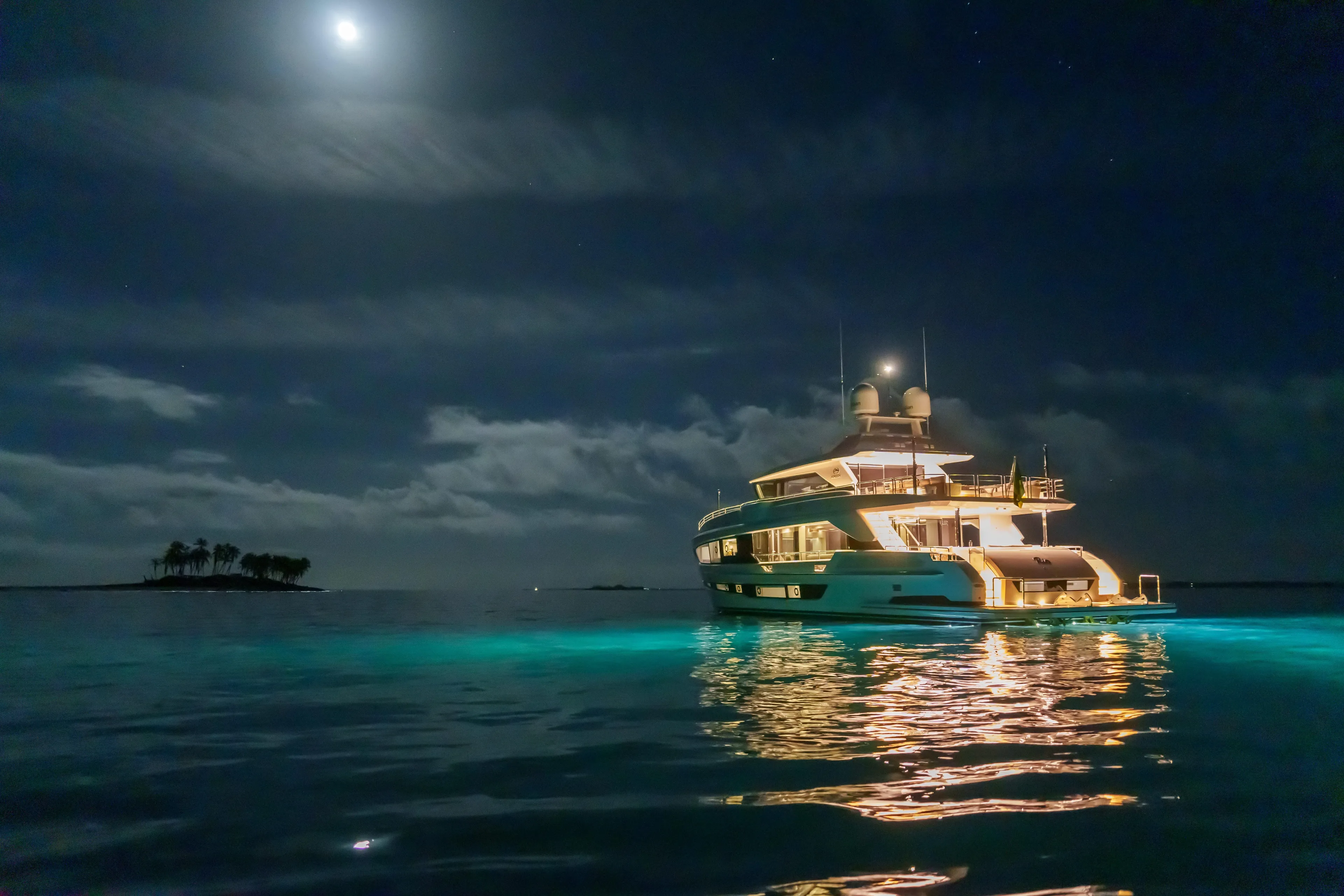 Rio Yacht Photos Pics Luxurious 2023 Horizon FD90 yacht illuminated at night under a moonlit sky.