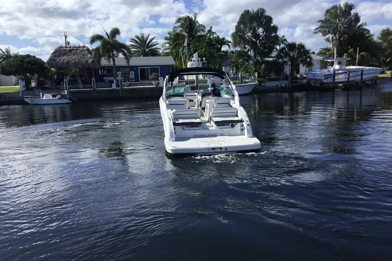 Enbarr Yacht Photos Pics 2017 Regal 3200 Bowrider boat cruising on a calm, scenic waterway.