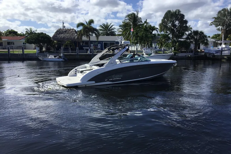 Enbarr Yacht Photos Pics 2017 Regal 3200 Bowrider cruising on a sunny day near waterfront homes.