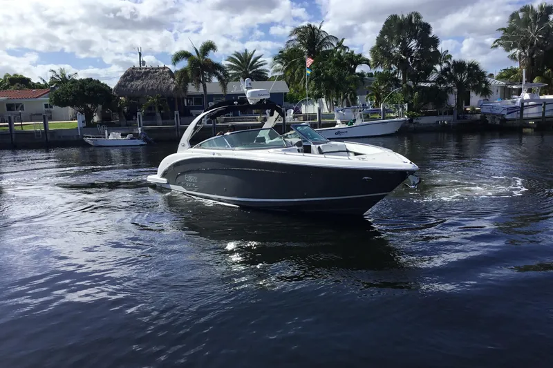 Enbarr Yacht Photos Pics 2017 Regal 3200 Bowrider boat cruising on a sunny day near waterfront homes.